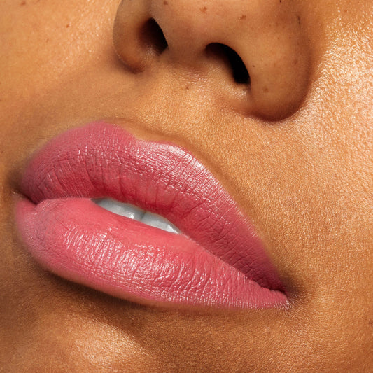 After Shock ColourPop Lippie Stix coating lips in a rosy pink shade with a soft, creamy sheen, shown in a close-up lip swatch to highlight smooth texture, rich color payoff, and precise application.