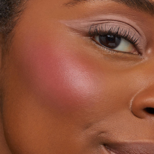Obviously ColourPop Cream Blush adding a dewy rosy glow to the cheek, smoothly blended along the cheekbone; extreme close-up with neutral eyeshadow and defined lashes showcases the blendable pigment and radiant, natural skin finish.