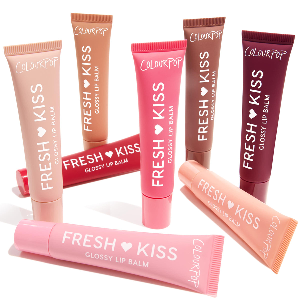 Eight ColourPop Fresh Kiss Glossy Lip Balm tubes fan out on white, some upright and one laid across, displaying nude, pink, coral, red, brown, and berry shades; Gloss Goals Full Collection Set, a ColourPop Full Collection Set for shiny, hydrated lips.