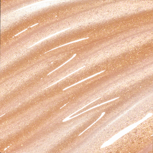 Colourpop Fresh Kiss Glossy Balm Buttery Pancakes swatch showing sheer nude lip gloss & lip oil texture with gold, pink, and silver sparkle streaked across a shimmery beige background, highlighting its high-shine finish.