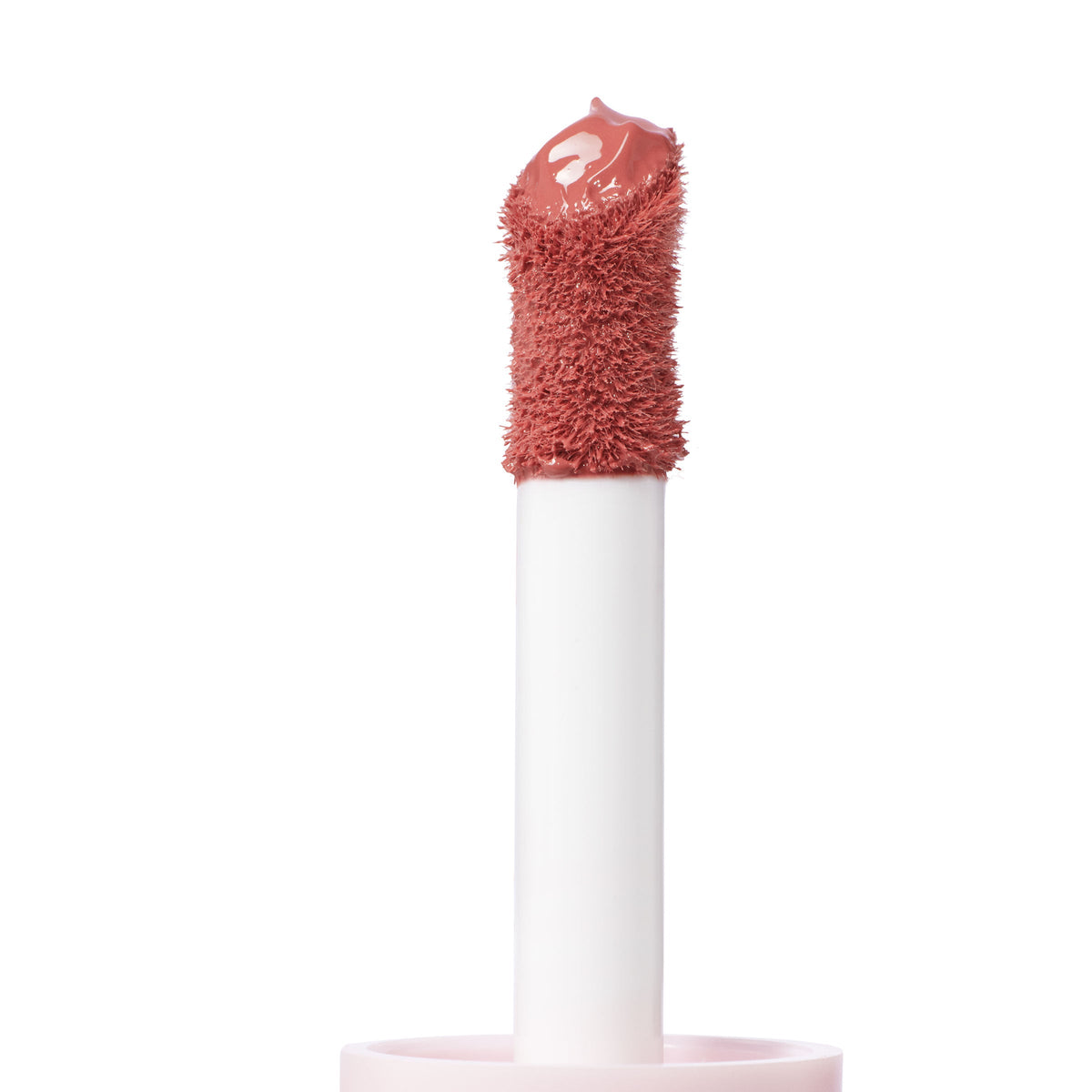 Doe-foot applicator swiping THX ColourPop Liquid Blush, a creamy rosy nude, captured in macro on a white background, showing the plush sponge tip loaded with glossy pigment for precise, blendable cheek color.