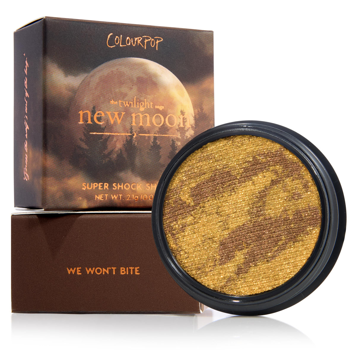 We Won't Bite ColourPop Super Shock Shadow displays a marbled gold and deep bronze shimmer in a round pot, propped against Twilight New Moon packaging atop a brown box labeled We Won't Bite; 2.1 g creme-to-powder eyeshadow.