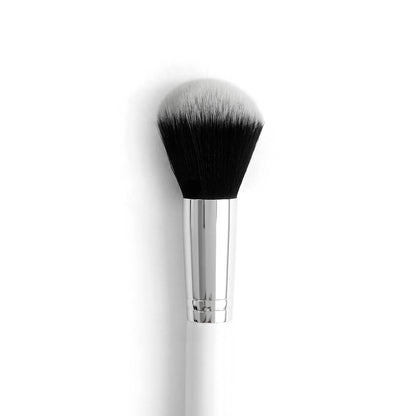 Large Powder Brush poised to sweep loose or pressed powder across the face, with a rounded dome of dense black-to-white bristles, a polished silver ferrule, and a white handle; ColourPop makeup brush on a clean white background.