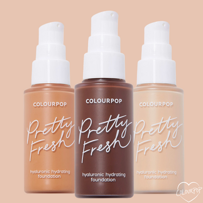 Three pump-top bottles of ColourPop Hyaluronic Hydrating Foundation (Pretty Fresh) stand side by side, showing light, medium, and deep tones; lineup includes the Fair 15 W shade, in frosted bottles with white pumps on a peach background.