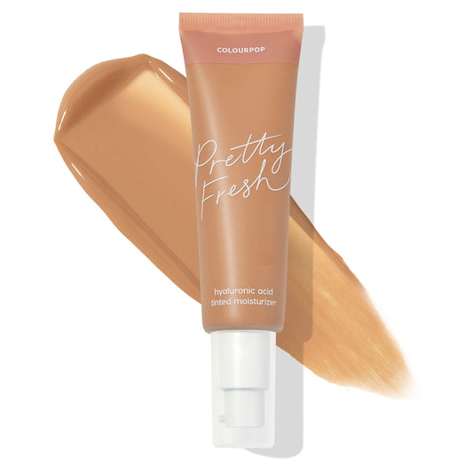 ColourPop Pretty Fresh Tinted Moisturizer in Medium 11 N stands upright with a broad tan swatch behind, showing the hydrating hyaluronic acid formula; peach-cap pump tube with “Pretty Fresh” script branding on a clean white background.