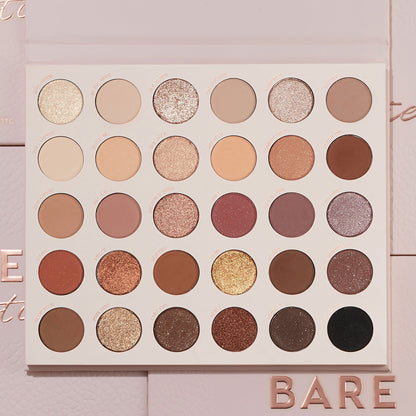 Bare Necessities ColourPop Shadow Palette showcasing 30 neutral matte and shimmer shades in a 6x5 grid - ivory, taupe, mauve, bronze, gold, deep brown, and black - laying open on blush-pink packaging with BARE lettering, ideal for everyday looks.