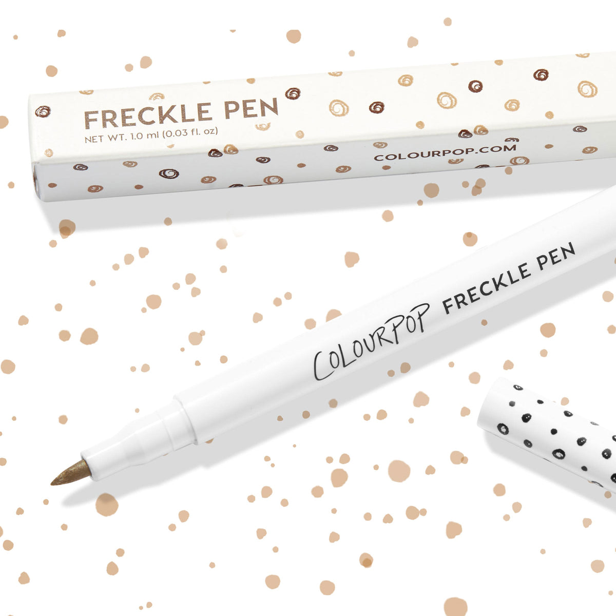 Soft Brown ColourPop Freckle Pen uncapped, felt-tip applicator ready to dot natural-looking freckles, shown with polka-dot cap and matching box on a white background speckled with brown spots; 1.0 ml makeup pen for faux freckles.