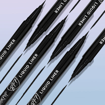 ColourPop BFF Liquid Liner in Black, brush-tip pen drawing sleek, ultra-pigmented lines, with multiple pens angled diagonally and inky strokes on a soft gradient background - ideal for precise wings and long-wear eyeliner looks.