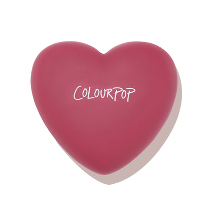 Heart-shaped rosy-pink compact with white ColourPop logo presenting Babycakes pressed powder blush, closed on a white background; ColourPop Pressed Powder Blush in a cute heart case.
