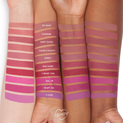 ColourPop Lippie Pencil swatches shown on three arms in light, medium, and deep tones, featuring the I Heart This shade - a bold raspberry red - placed between Bad Habit and Dial Up in the lineup of labeled colors.