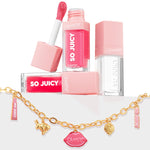 ColourPop So Juicy Lip Oil and Necklace Set, Charmed and Juicy, displaying pink and clear plumping lip oils stacked with one open doe-foot applicator, paired with a gold charm chain necklace featuring lips, bunny, strawberry, and So Juicy tag charms on a white backdrop.