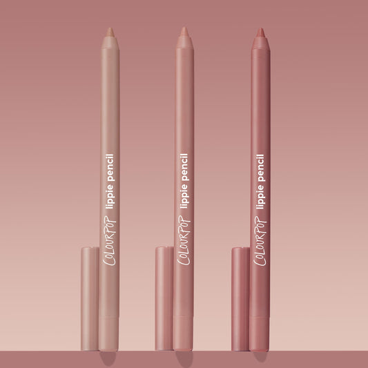 Trio of ColourPop Lippie Pencil Cool Besties standing upright, tips exposed, in light nude, pink nude, and rosy mauve tones with matching caps, arranged on a blush gradient background for a clean product shot.