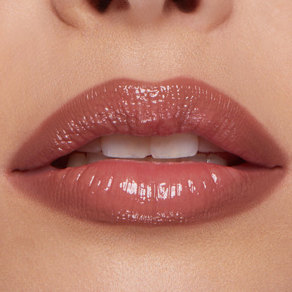 Glossy rosy nude lips wearing the Go-To Lip ColourPop So Juicy Plumping Lip Liner & Balm Set, showing smooth definition and fuller-looking shine in a tight, close-up beauty shot.