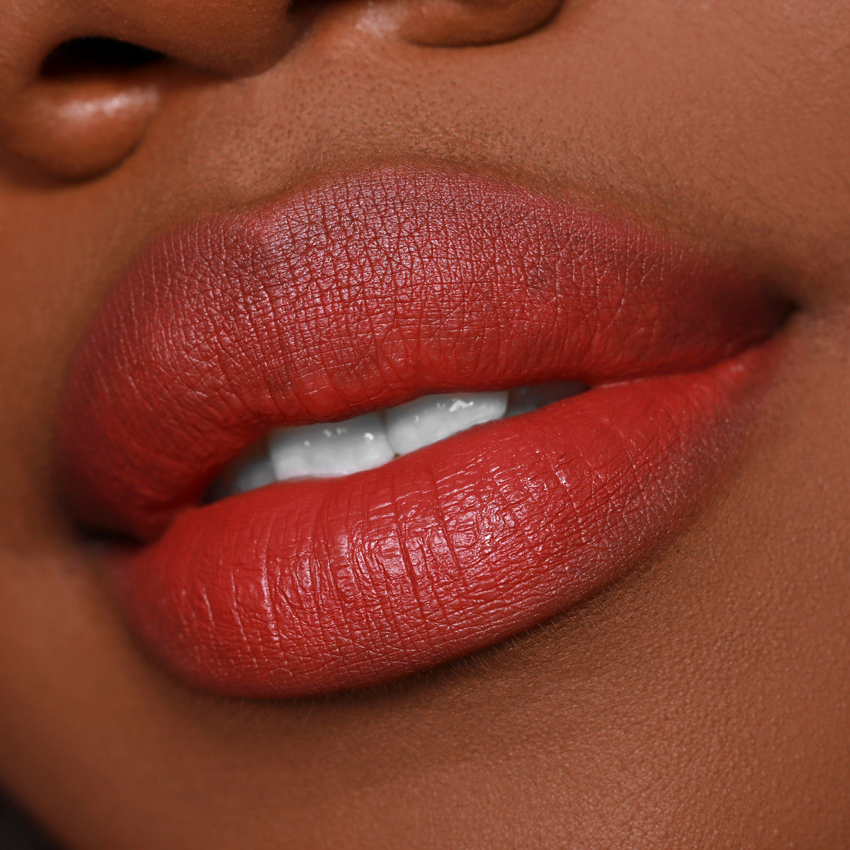 Full lips wearing Bumble ColourPop Lippie Pencil, a warm terracotta red lip liner used to define and fill for a smooth, creamy finish, shown in an extreme close-up beauty shot.