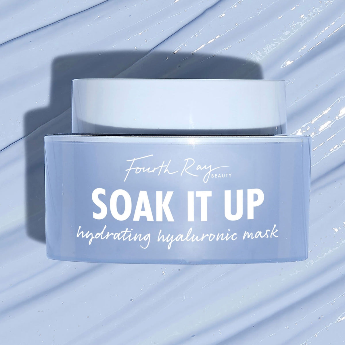 Fourth Ray Beauty Soak It Up Hydrating Mask jar shows “hydrating hyaluronic mask” as it rests on a glossy, water-swept pale blue surface; frosted periwinkle square container with white lid, a ColourPop Face Mask for dewy hydration.