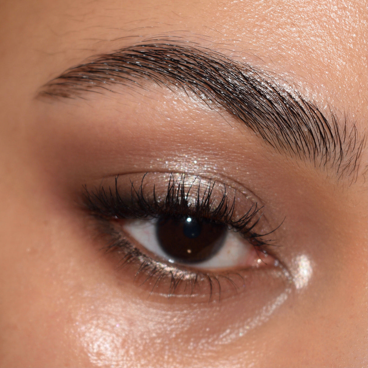 Shimmering taupe eyeshadow on a brown eye, softly blended with a matte crease and inner-corner highlight, created using The Ultimate Stunner ColourPop Shadow Palette & Brush Set; close-up showcases precise brushwork and natural lashes.