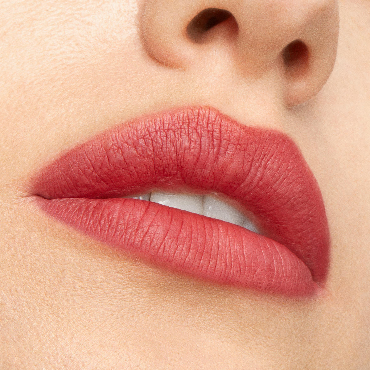 Rosy coral lips wearing Blush n’ Pout from ColourPop Cheek & Lip Set, showing smooth velvety‑matte payoff; extreme close-up studio shot highlights even coverage and soft-focus finish around the mouth and nose.