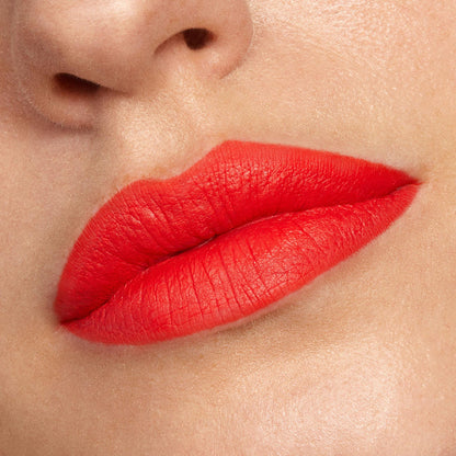 Matte orange-red lips wear Chi Chi Lippie Stix, captured in a close-up beauty shot on natural skin, showing smooth full coverage and crisp edges, ideal to pair with a ColourPop Lippie Pencil for precise lip lining.