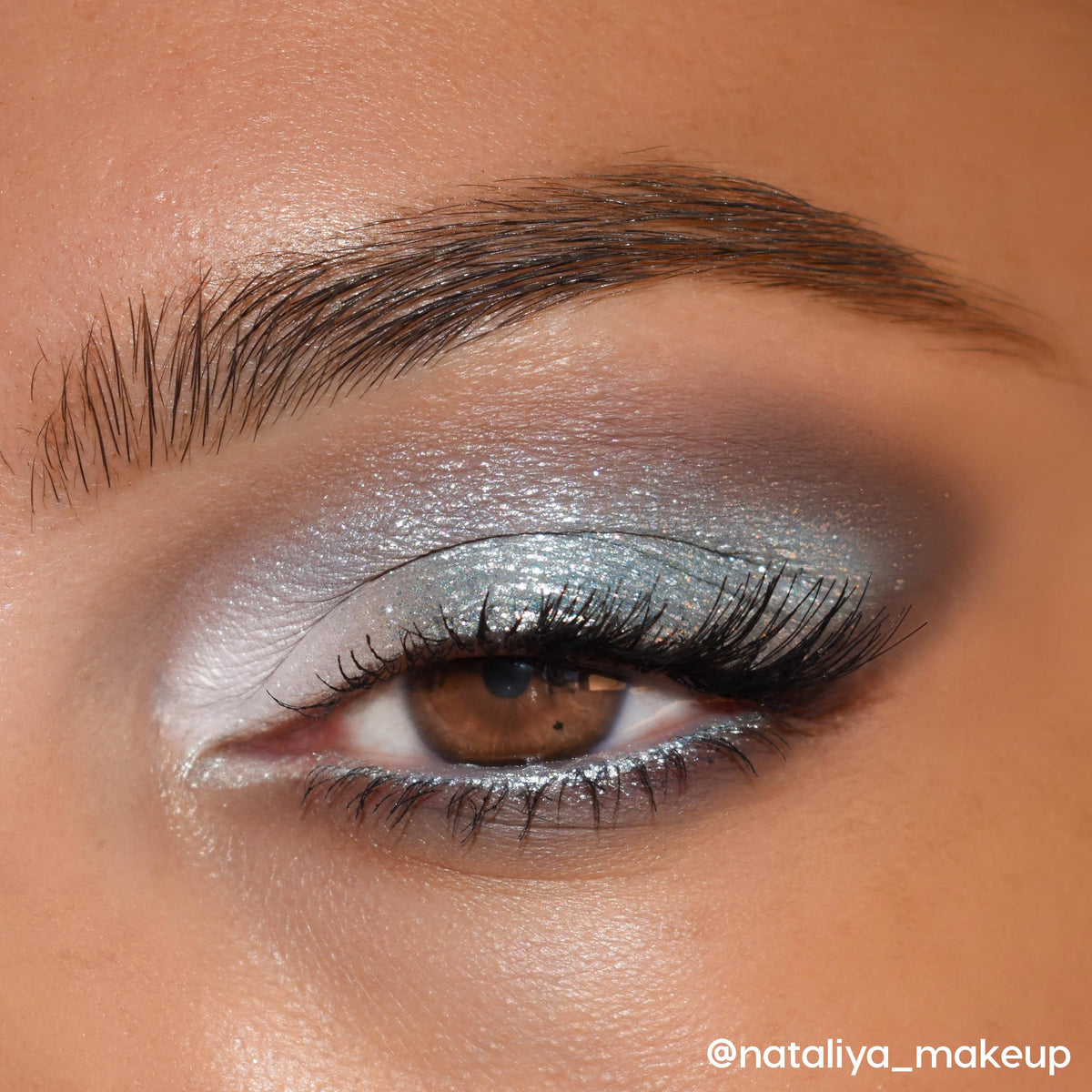 Shimmery icy blue-silver eyeshadow sweeps across a brown eye with a white inner-corner highlight and soft gray smoke, lashes defined - showcasing the Cloud 9 Shadow Palette, a ColourPop Shadow Palette, in a close-up makeup look.