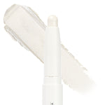 Cold Girl ColourPop Shadow Stix standing upright with its twist-up bullet exposed, showing an icy pearl white shimmer; a broad swatch of the creamy eyeshadow sits behind on a clean white background.