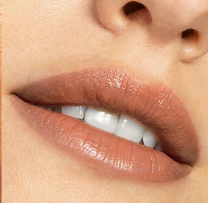 Softly parted lips wearing Cookie, a warm nude ColourPop Lippie Stix, showing creamy satin coverage and subtle shine in a tight beauty close-up.