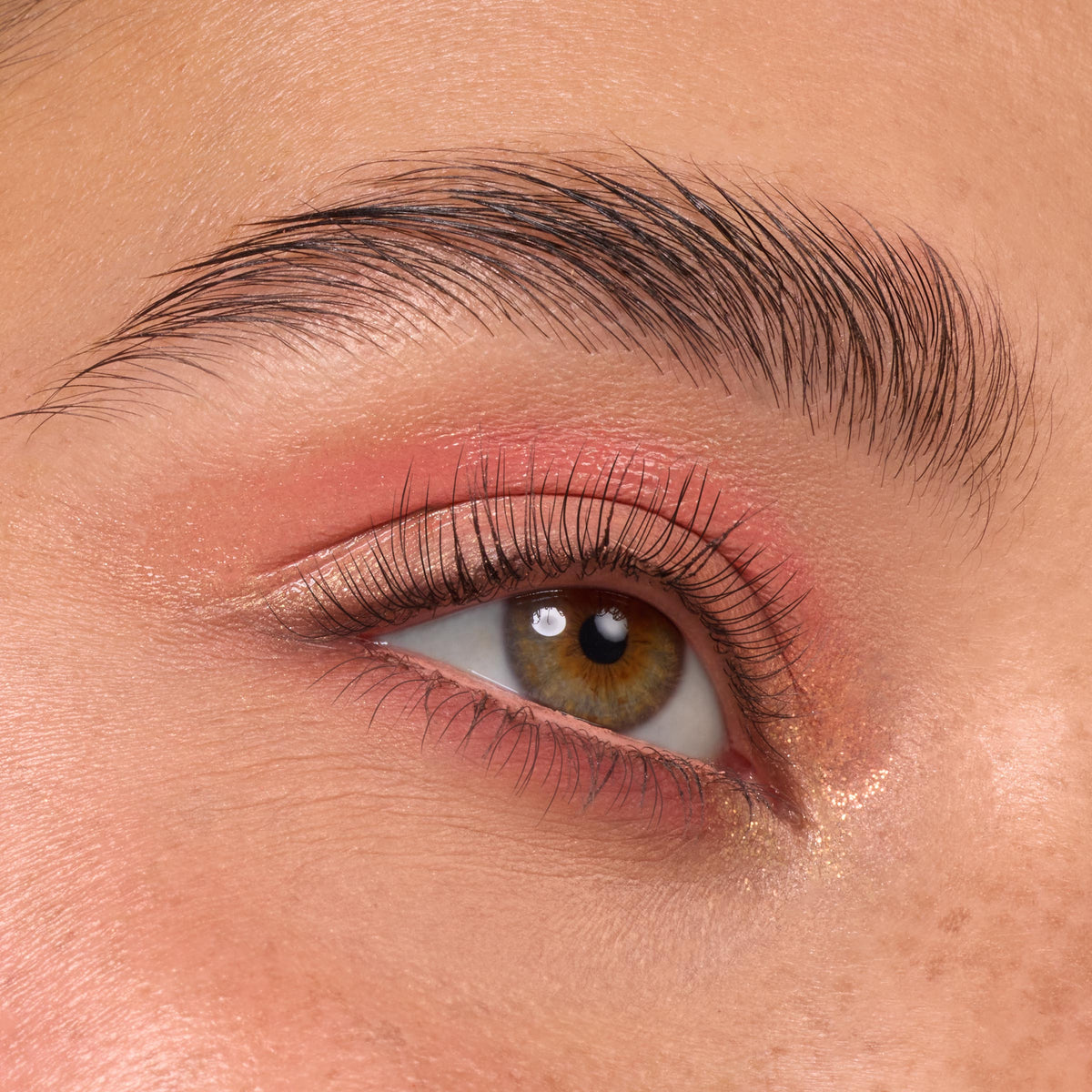 Close-up eye shows warm peach matte and subtle gold shimmer from the Baby Got Peach ColourPop Shadow Palette, blended across the lid and inner corner with natural lashes and a defined brow.