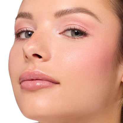 Model showcases Blush Baby ColourPop Shadow Palette, wearing soft pink shimmer eyeshadow with blended rose hues, natural lashes, and rosy blush, finished with glossy nude lips in a clean studio close-up.