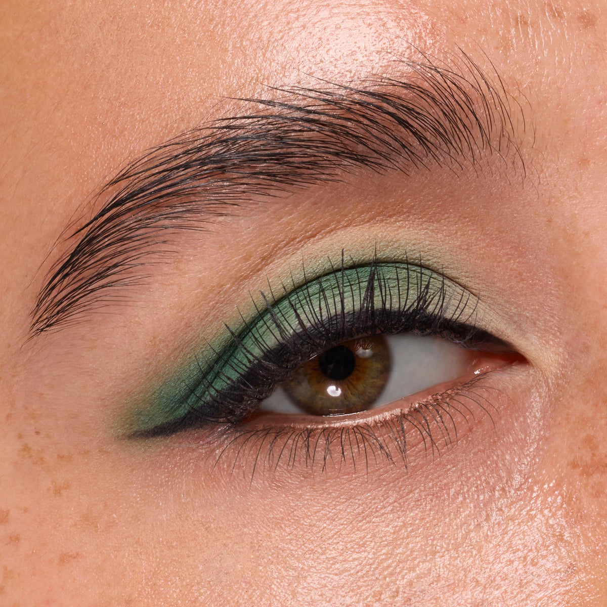 Hazel eye wears mint-to-emerald green shadow, showcasing the Just My Luck ColourPop Shadow Palette, with matte shades softly blended into a wing and paired with black liner in a tight beauty macro.