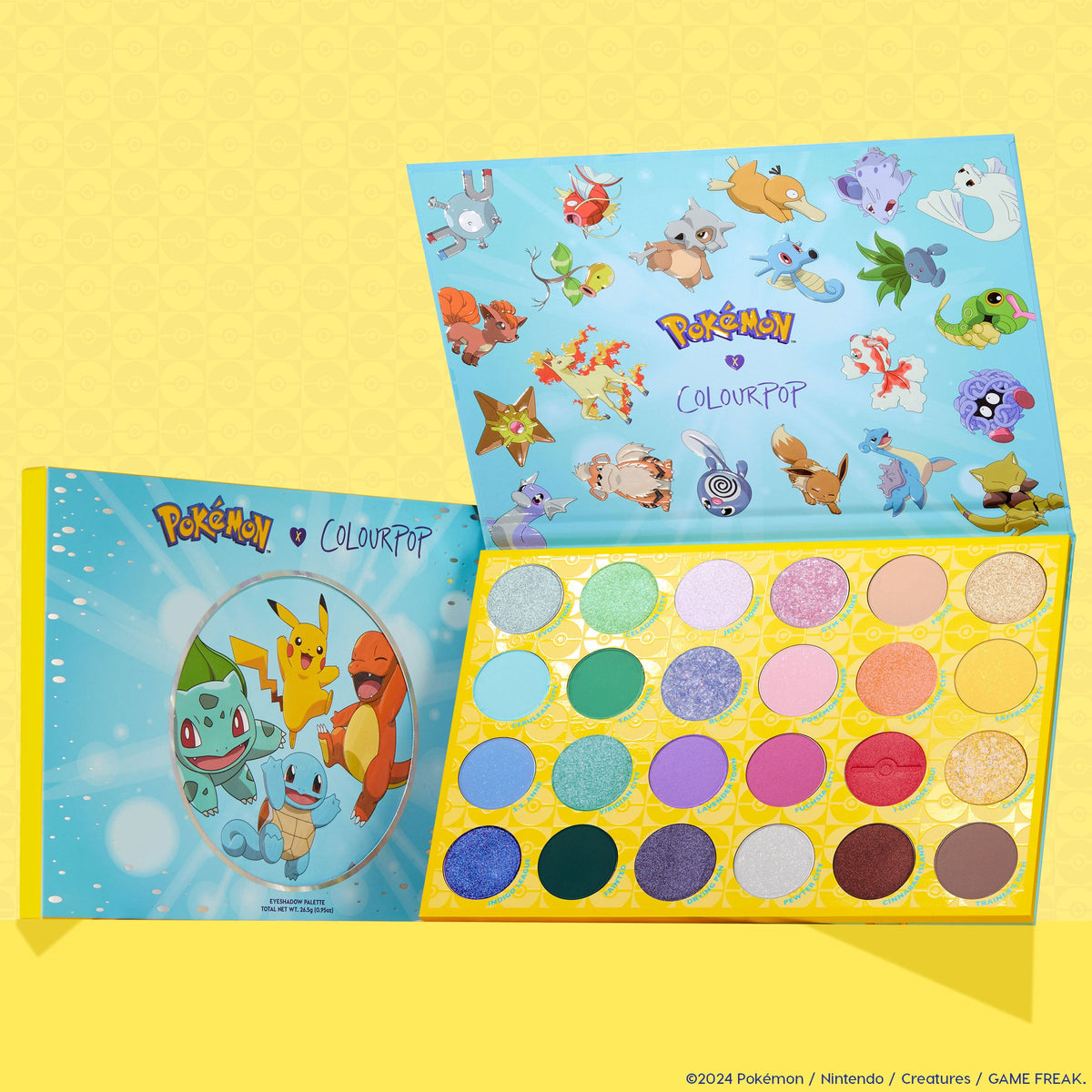 Pallet Town ColourPop Shadow Palette opens to reveal 24 round pans of pastel, bright, and shimmer shades in a yellow tray, with a blue lid featuring Pokémon art like Pikachu, Charmander, Squirtle, and Bulbasaur on a playful yellow backdrop.