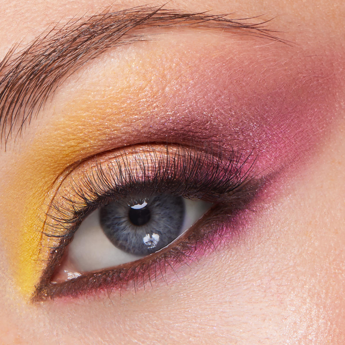 Sunset gradient eye makeup blending matte yellow inner corner, gold shimmer lid, and magenta‑plum crease and lower lash line on natural lashes, created with the Partner Up ColourPop Shadow Palette & pH Lipstick Set for bold, blendable color.