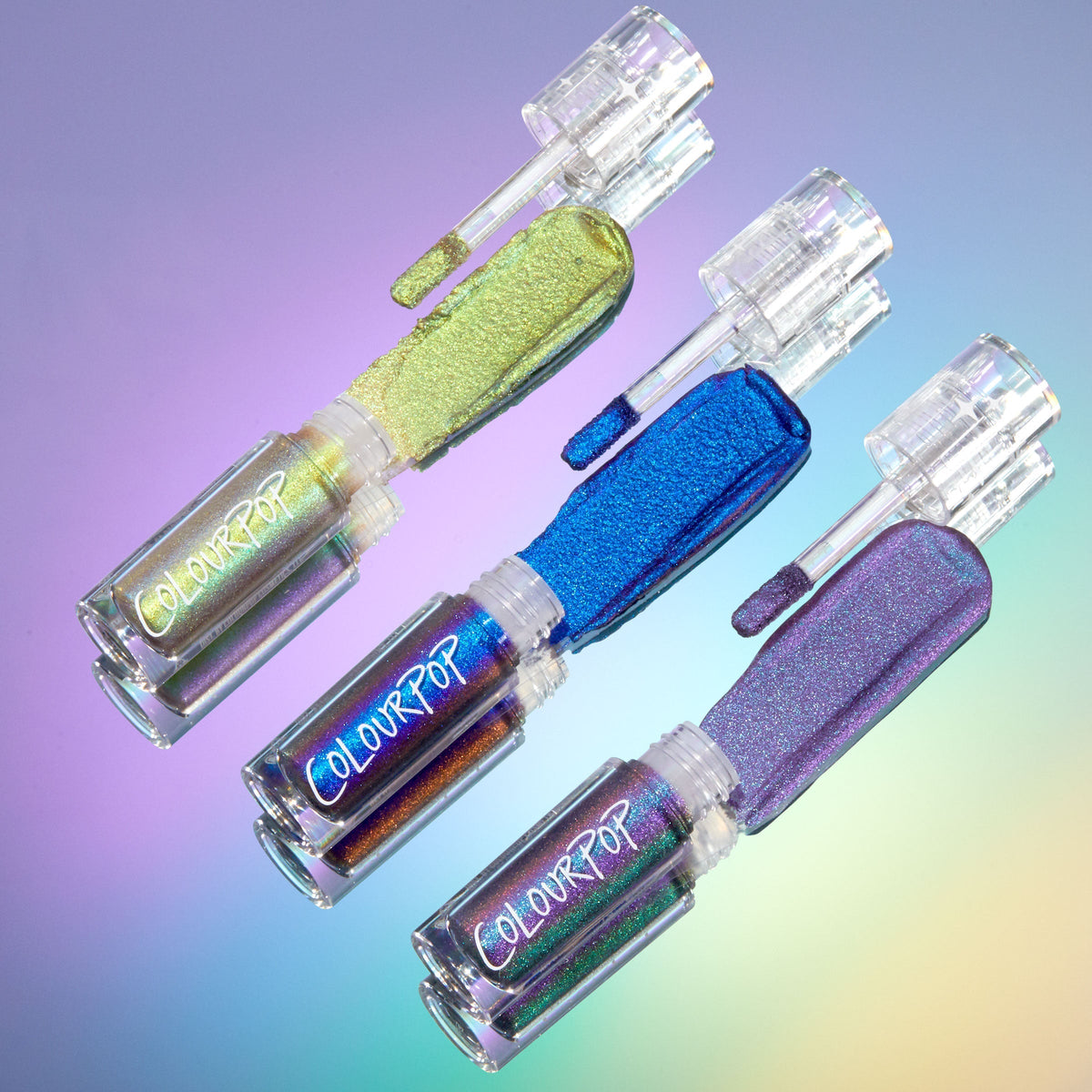 Feelin’ Bold ColourPop Chrome Liquid Shadow bundle displaying swatches on doe‑foot applicators in lime chartreuse, electric cobalt, and lavender shifts, with clear ColourPop tubes set on an iridescent gradient background.