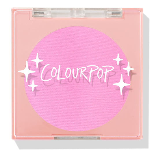 ColourPop Pressed Powder Blush in Flamingo shows a vibrant hot pink pan inside a square peach compact with a clear lid and white sparkles logo, closed and travel-friendly on a light background.
