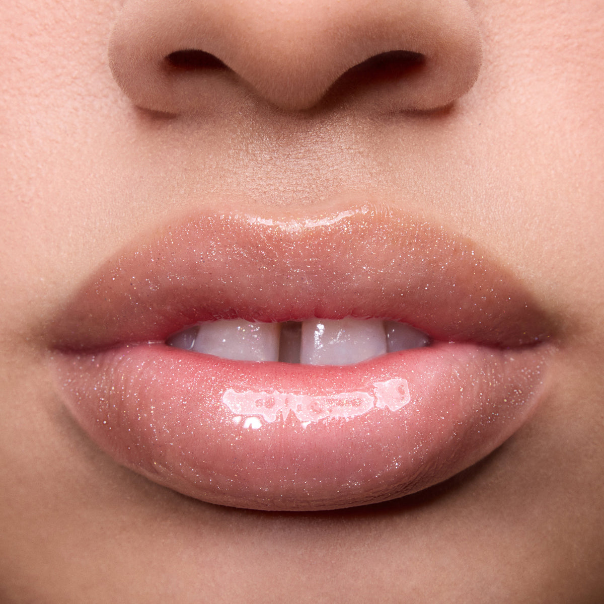 Close-up of models’ lips wearing Colourpop Fresh Kiss Glossy Balm in Whipped Cream, showing sheer nude shine and shimmer finish, highlighting Lip Gloss & Lip Oil texture on different skin tones against a plain background.