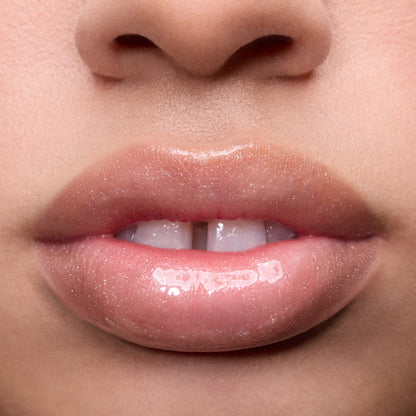 Close-up of models’ lips wearing Colourpop Fresh Kiss Glossy Balm in Whipped Cream, showing sheer nude shine and shimmer finish, highlighting Lip Gloss & Lip Oil texture on different skin tones against a plain background.