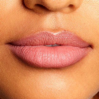 Soft mauve-pink lips lined and filled with the Good N Plenty shade, highlighting the creamy, satin finish and crisp edges of the ColourPop Lippie Pencil in a tight close-up of the mouth against natural skin.