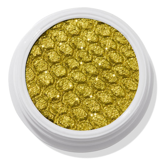 ColourPop Super Shock Shadow Green Juice shimmering in a close-up, the metallic chartreuse green-gold shade sparkles across a dimpled honeycomb texture, housed in an open white round pot on a clean studio background.