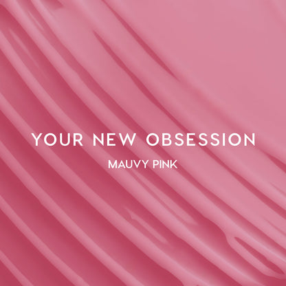 Heart to Get Sorry Not Sorry blush + UGL set swatched in smooth mauvy pink stripes, showing creamy, highly pigmented color payoff against a glossy pink background for modern US makeup lovers.