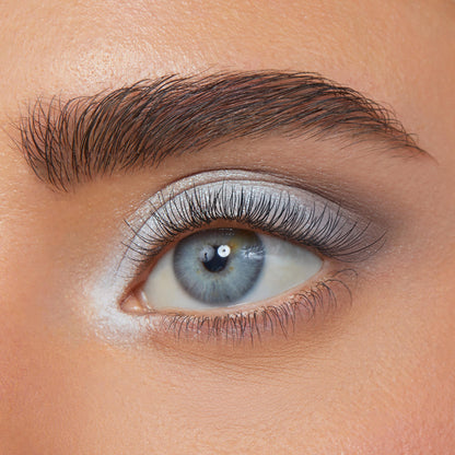 Blue eye wearing icy blue-to-silver shimmer with soft gray crease and bright inner-corner highlight, showcasing smooth payoff and blend from the Cloud 9 ColourPop Shadow Palette; tight close-up with natural lashes and groomed brow.