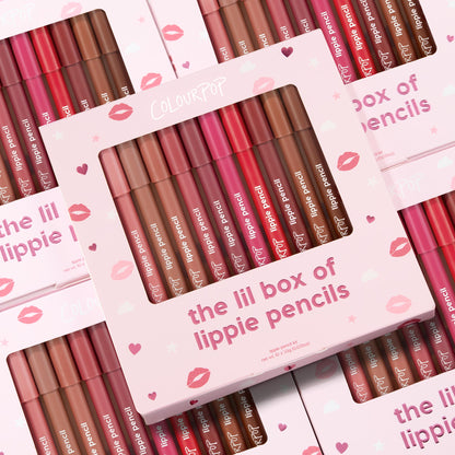 ColourPop Lippie Pencil set presenting The Lil Box of Lippie Pencils, a multi-shade lip liner kit displayed in a pink box with a clear window; pencils in nude, pink, and red tones lined up, with stacked kiss-print packaging in the background.