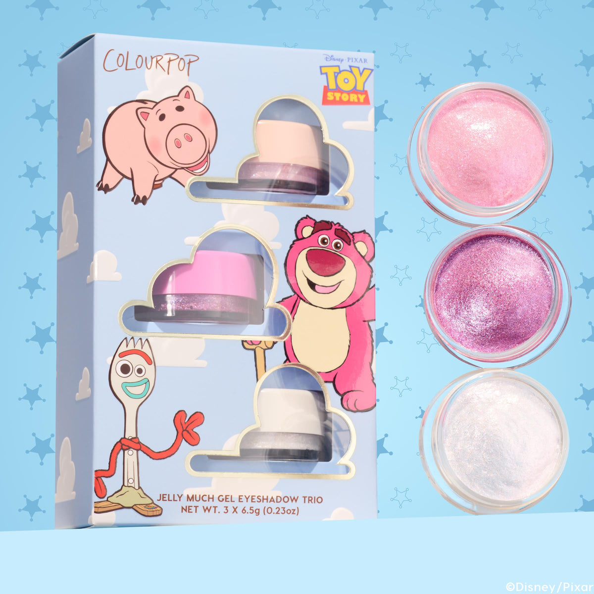ColourPop Jelly Much Shadow Play All Day trio showcasing three shimmery gel eyeshadows - pearl pink, vibrant magenta, and icy white - lined in open pots beside a Disney Pixar Toy Story sky-blue box with Hamm, Lotso, and Forky; set includes 3 x 6.5g jars.