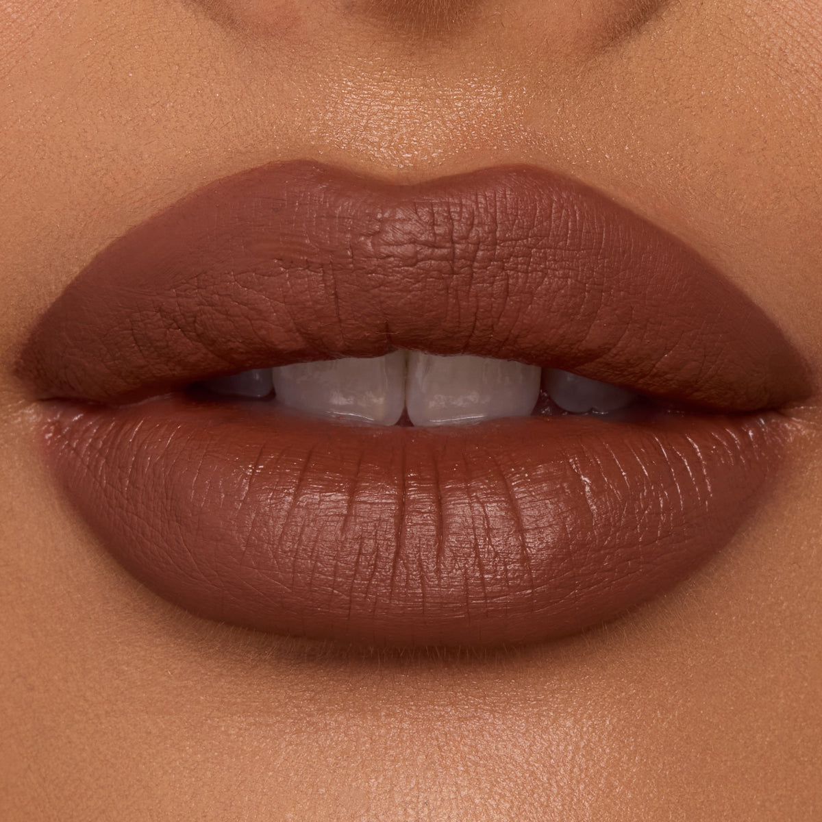 Lips wearing ColourPop Ultra Blotted Lip in Espresso Martini, a warm espresso-brown shade, shown close-up to showcase its soft-matte blotted finish and smooth, even coverage under studio lighting.