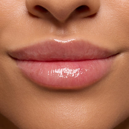 Glossy, hydrated pink lips showing a smooth, plumped finish, demonstrating the Strawberry Feels ColourPop Lip Care Kit in a tight close-up of the lower face with natural skin tone.
