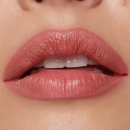 Full lips wearing ColourPop Lippie Pencil in Five Stars, lining and filling with a warm rosy nude shade and soft satin finish, shown in a tight close-up to highlight crisp edges and even color payoff.