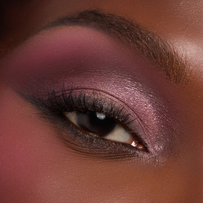 Eyelid flaunting metallic rose‑pink shimmer and a smoky plum crease, created with the Smoke 'N Roses ColourPop Shadow Palette, featuring a soft matte rose transition, tightlined lash line, and defined lashes in a close-up studio shot.