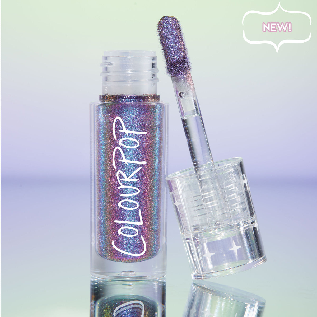 Same Vibe ColourPop Chrome Liquid Shadow displayed open with a doe-foot applicator leaning on the clear, star-printed cap; the liquid shows a purple-to-teal multichrome shimmer, white COLOURPOP logo visible, on a pastel gradient backdrop marked NEW!