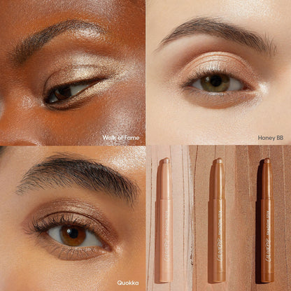 ColourPop Shadow Stix Shimmering Golds enhancing lids with luminous gold, shown in a grid: close-ups wearing Walk of Fame, Honey BB, and Quokka plus three twist-up sticks on a wood backdrop, demonstrating payoff across multiple skin tones.