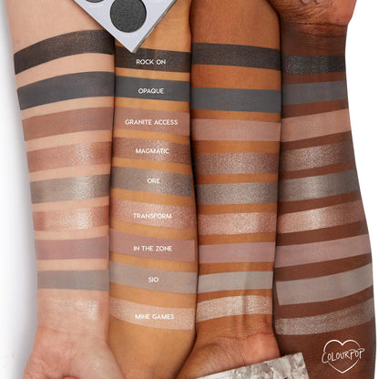 ColourPop Of Quartz Shadow Palette swatches span three arms, showing cool‑toned taupe, gray, and metallic neutrals - Rock On, Opaque, Granite Access, Magmatic, Ore, Transform, In the Zone, Sio, Mine Games - with the palette corner visible.