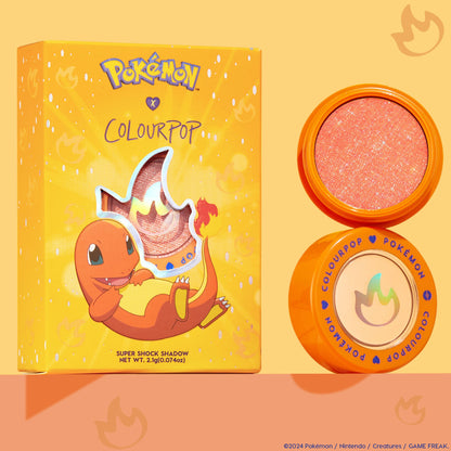ColourPop Super Shock Shadow in Flamethrower, a sparkly peach‑orange metallic eyeshadow, shown open in an orange pot beside the Pokémon x ColourPop box featuring Charmander and a flame cutout, on a warm peach background.