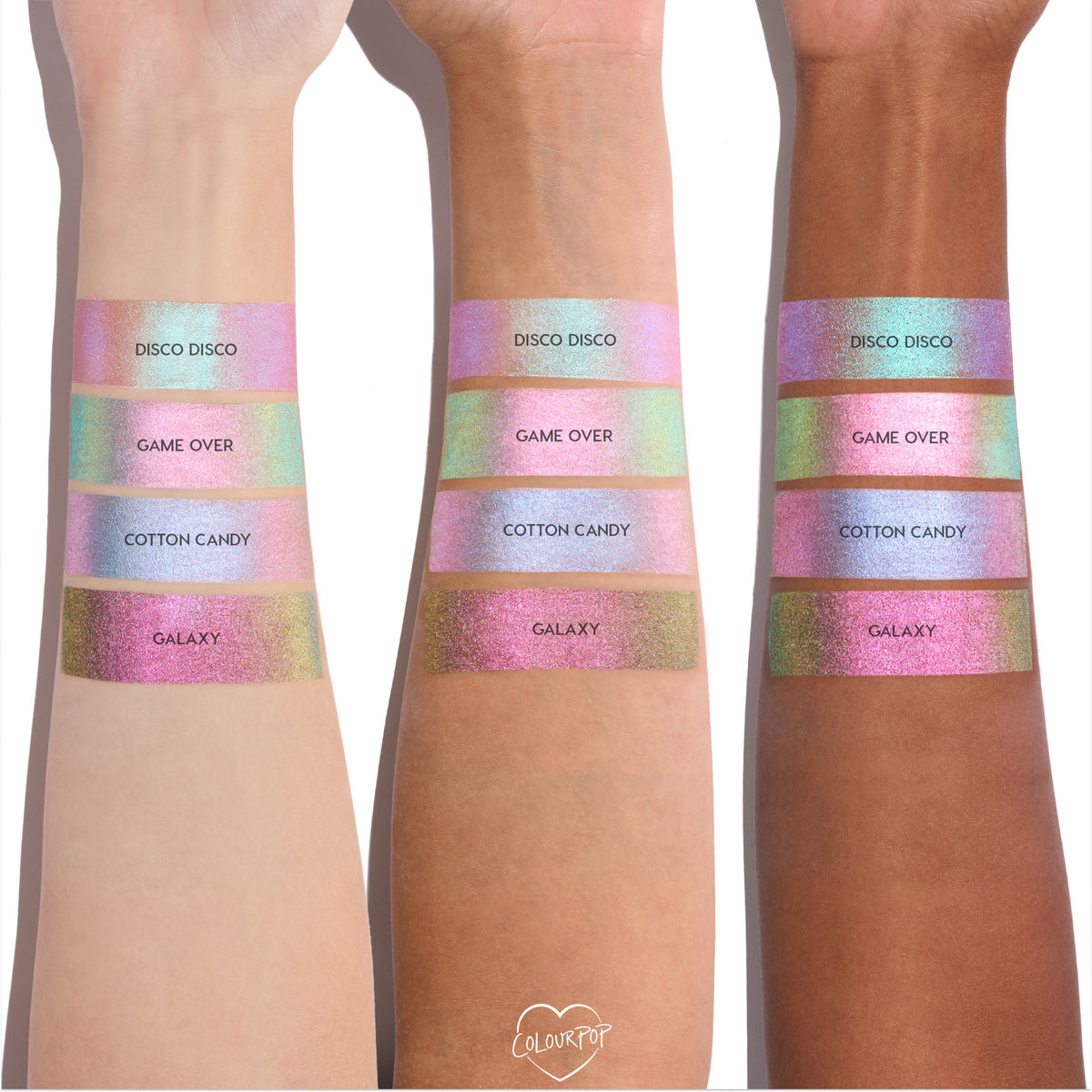 Colourpop Disco Disco Shadow Stix swatched on three skin tones, showing the shimmery pink duochrome finish alongside Game Over, Cotton Candy, and Galaxy shades in wide metallic bands on forearms.