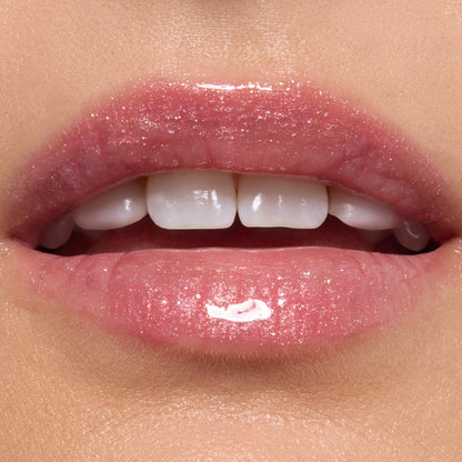Glossy lips wearing ColourPop Ultra Glossy Lip in Totally Swamped, a sheer pink shimmer with fine sparkle, reflecting high shine in a studio close-up to showcase the smooth, hydrated finish.